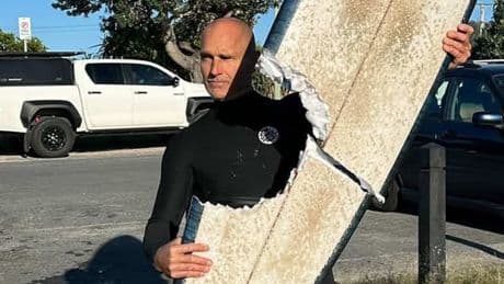 Surfer miraculously escapes shark attack that left board torn in half