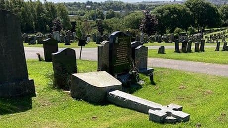 Crucifix set on fire and headstones vandalised in 'senseless' attack on graveyard
