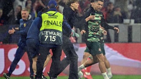 Major security breach as Cristiano Ronaldo is grabbed by pitch invader before guards are forced to intervene
