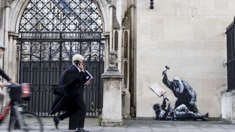 Banksy artwork showing judge beating protester appears on London, U.K. court wall