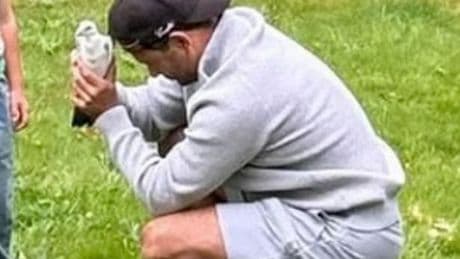 Ryan Thomas breaks down holding a pigeon he believes is his reincarnated father