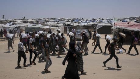 Palestinians say Israeli fire kills 5 near aid sites. Israel says it fired warning shots