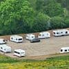 Travellers in fleet of caravans take over huge field in the South Downs National Park after the land was illegally torn up by diggers over Bank Holiday weekend