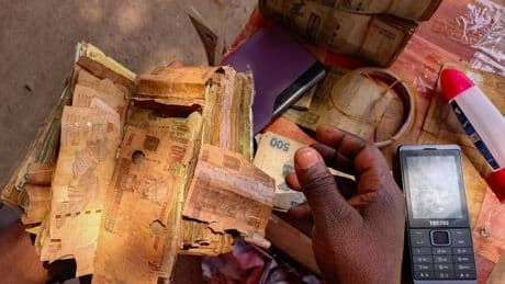 A rebel-held Congolese city uses damaged banknotes due to a cash shortage