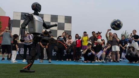 Photos show how humanoid robots captivate fans in China by playing a soccer match