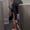 Shock moment flight attendants wrestle female passenger to ground after she tried to storm cockpit on plane to New York