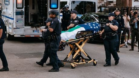 A Fallen Officer’s Flag-Wrapped Body Makes a Somber Journey to a Mosque