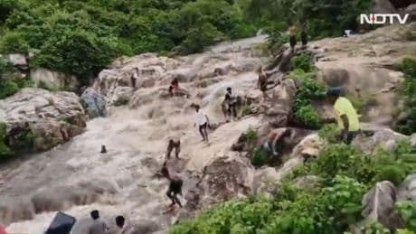 Terrifying moment six girls swept away by a sudden flood surge towards waterfall’s edge