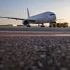 Passengers are seen running across tarmac as they flee jet after 'landing gear caught fire'