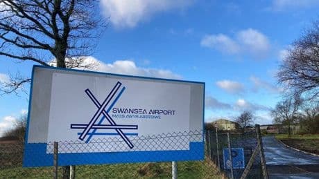 Plane crashes and flips at Swansea Airport after 'pilot error' leaves two injured