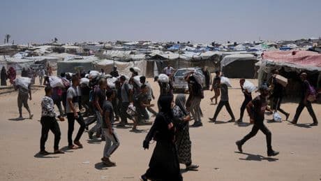 Palestinians say Israeli fire kills 5 near aid sites. Israel says it fired warning shots