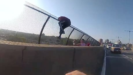 Heart-stopping moment NYPD officer races to grab woman trying to jump off bridge