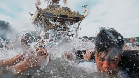 Photos show a town praying for marine safety at a seaside festival near Tokyo