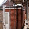 Locals on quiet cul-de-sac 'at their wits end' after neighbour turns back garden gym into home and moves a whole FAMILY in... and another adds an extra storey to their garage
