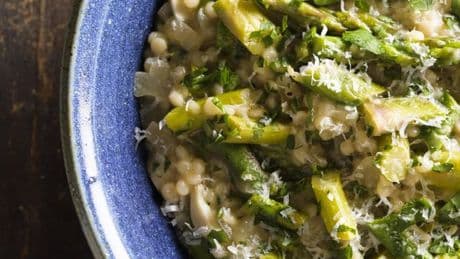 Couscous gets the risotto treatment in this creamy springtime recipe
