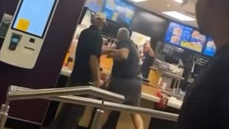 Moment McDonald’s customer climbs over counter and starts fighting staff