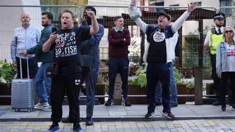 Police officer punched in face at anti-asylum protest in London