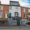 Homeowner ordered to take down dormer extension that looks like a 'football stadium executive box' after neighbours branded it 'a monstrosity'