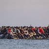 Grinning Channel migrants pose for SELFIES on packed dinghy as total tops 170,000 since start of crisis - and expert warns French powers to stop boats will make no difference to illegal arrivals
