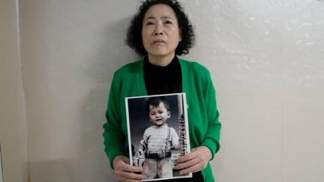 A South Korean mother sues the government and an agency over the adoption of her missing son