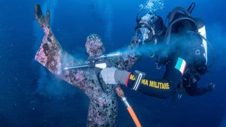 Italian divers water-blast the popular underwater statue of Christ off Portofino