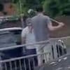 Moment angry driver gets in road rage row with rival motorist while armed with golf club