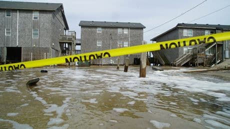 Hurricane Erin stirs up strong winds, floods part of main highway as it creeps along the East Coast