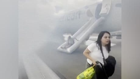 Passengers flee smoking plane on emergency slides after aborted takeoff in Denver
