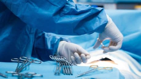 Doctor who posted image of himself performing brain surgery on dating website struck off