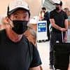 Hugh Jackman forced to wait in security line at Miami International Airport as he struggles to print out baggage claim slip