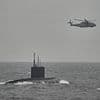 Moment Royal Navy warship and helicopters shadow a Russian submarine as it glides past the English coast