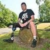 One-legged amputee has his benefit payments slashed after officials catch him playing cricket - despite help from a runner and umpire holding his crutch