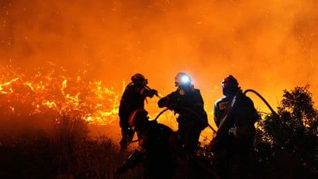 Firefighters battle a wildfire burning out of control on the Greek island of Chios