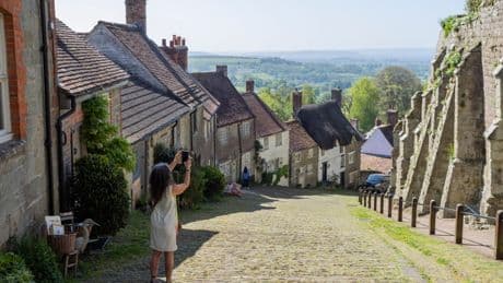 We live on hill made famous by iconic advert – but it’s flooded by tourists playing theme tune… they think we’re actors