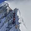 The queue at the top of the world: Dozens of climbers wait for their turn to reach the top of Mount Everest in human traffic jam