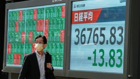 Asian shares trade higher after Wall Street climbs moderately as Fed holds rates steady