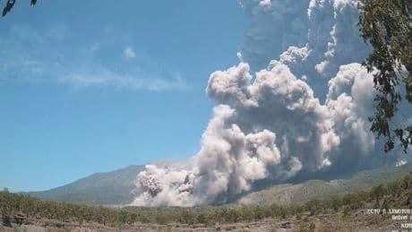 Residents wear masks as volcanic ash blankets villages near erupting Indonesian volcano