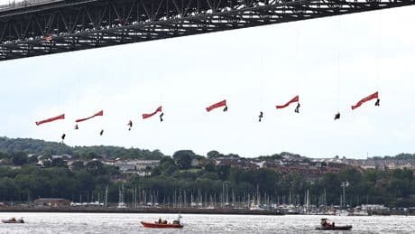 Ten Greenpeace activists arrested after suspending themselves from bridge