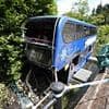 Off-duty ambulance worker jumped into river to save screaming children after bus crash - as 'hero' driver, 69, and girl, 16, are still in hospital with major injuries