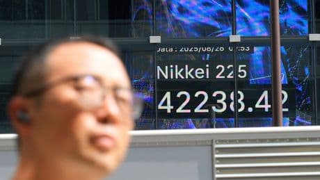 Asian shares post modest gains after Wall Street nears more records