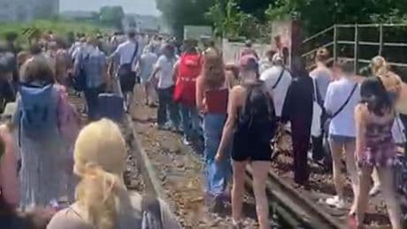 Rail passengers have to walk along tracks on hottest day of year after fault brings trains to halt