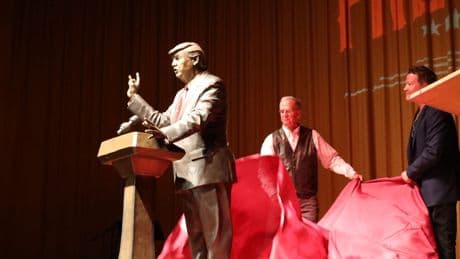 Trump statue unveiled in South Dakota city to half-filled auditorium as protesters gathered outside