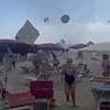 Shocking moment tourists flee as TORNADO hits Italian beach, sending parasols spinning through the air and injuring at least one person - as gigantic waterspouts also strike coast