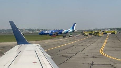 Plane skids off runway into grass while landing in Boston