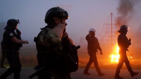 French riot police in early morning clash with migrants in coastal town