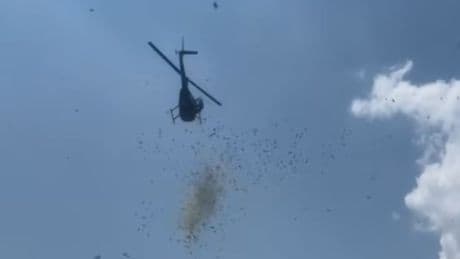 Cash rains from helicopter onto mourners to honour Detroit man’s last wish