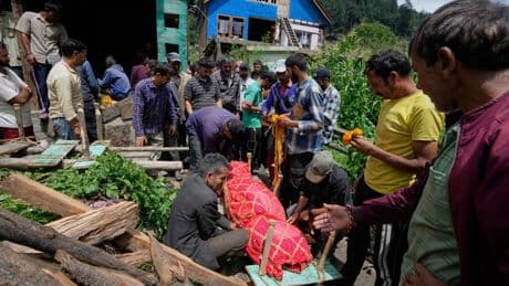 Photos of mourners and searches for the missing from flash floods in Pakistan and India