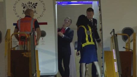 France's first lady seems to push her husband as they land in Vietnam. He says they were joking