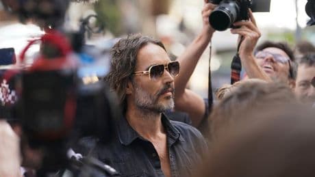 Russell Brand arrives at a London court to face rape and sexual assault charges