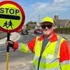 Council bans lollipop man from high-fiving children as they cross the road because of health and safety concerns and claims it 'slows down traffic'